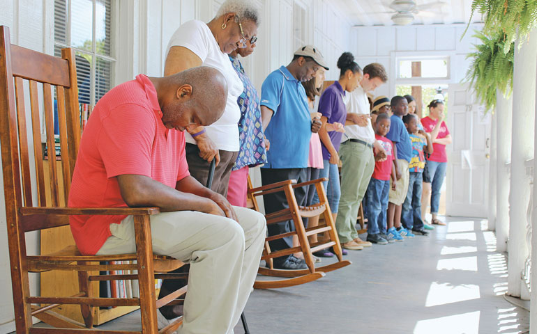 Members of the Manna Life Center lead an ecumenical prayer service June 19 in Charleston, S.C., at the Neighborhood House, which is part of Our Lady of Mercy Community Outreach Center. They prayed for the victims of the shootings at Emanuel African Methodist Episcopal Church, and the children who lost their parents. (CNS/The Catholic Miscellany/Victoria Wain)