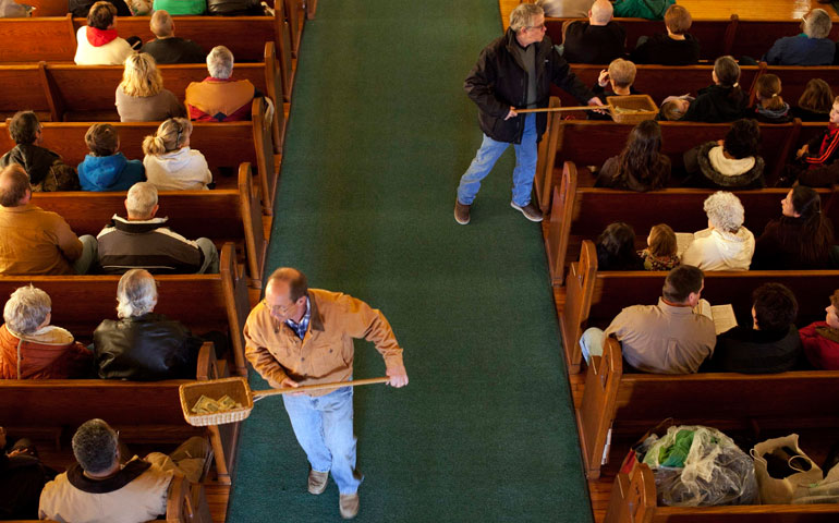 Parishioners take up a collection during Mass at St. Francis Xavier Church in Henryville, Ind., in 2012. (CNS/Reuters/Aaron P. Bernstein)