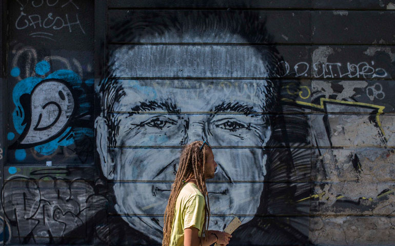 A man walks past a mural depicting the late actor Robin Williams in Belgrade, Serbia, Aug. 13. Williams, who had sought treatment for depression, committed suicide two days earlier. (Reuters/Marko Djurica)