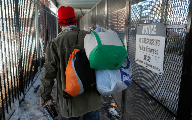 Mack Donohue, who has been homeless since 2008, carries his belongings into a shelter in Boston Feb. 27. (CNS/Reuters/Brian Snyder)