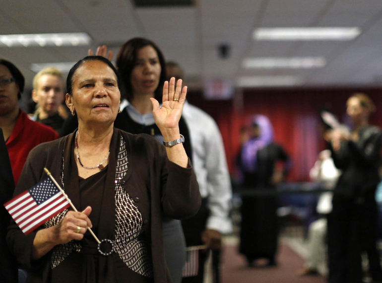 Immigrant Isabel Rivera from the Dominican Republic takes the oath of citizenship during a naturalization ceremony in New York, April 17. (CNS photo/Brendan McDermid, Reuters)