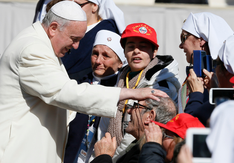 Pope Francis blesses a man in a wheelchair as he greets the sick and disabled during his general audience in St. Peter's Square at the Vatican March 5. (CNS/Paul Haring)