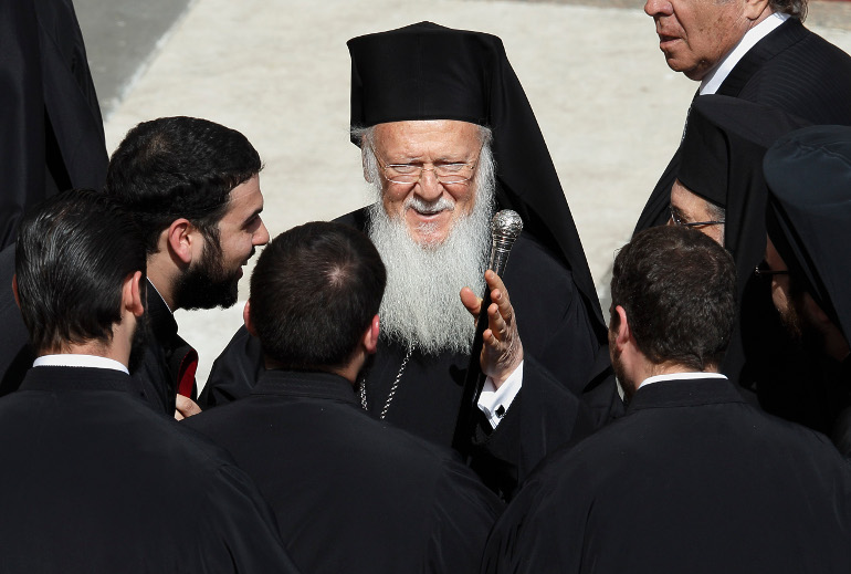 Ecumenical Patriarch Bartholomew, center, talks with delegates at the conclusion of Pope Francis' inaugural Mass in St. Peter's Square at the Vatican in this March 19, 2013, file photo. (CNS/Vatican)