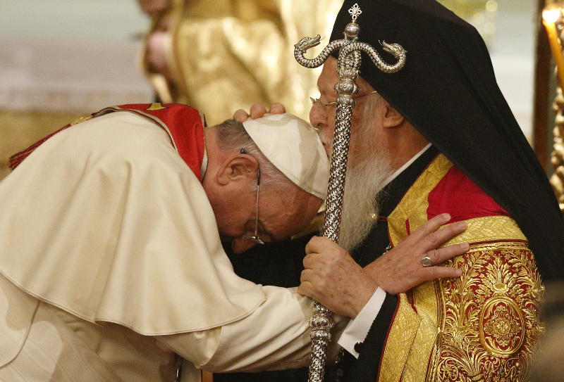 Ecumenical Patriarch Bartholomew of Constantinople kisses Pope Francis as they embrace during an ecumenical prayer service in the patriarchal Church of St. George in Istanbul Nov. 29. (CNS photo/Paul Haring)