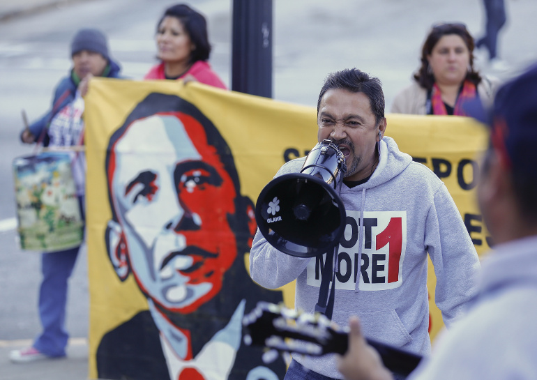 Tomas Martinez shouts into a megaphone during an immigration reform rally at the Atlanta City Detention Center in Atlanta Nov. 21. (CNS/EPA/Erik S. Lesser)