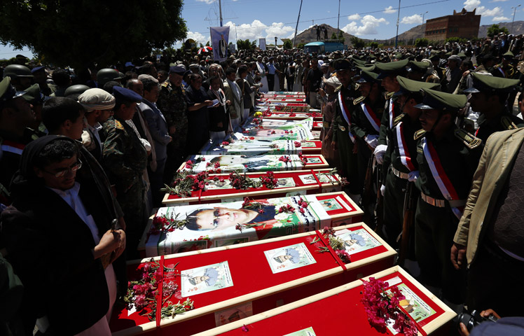 Yemeni mourners gather beside the coffins of the victims of suicide attacks during a funeral in Sana'a, Yemen, March 25. (CNS/Yahya Arhab, EPA)