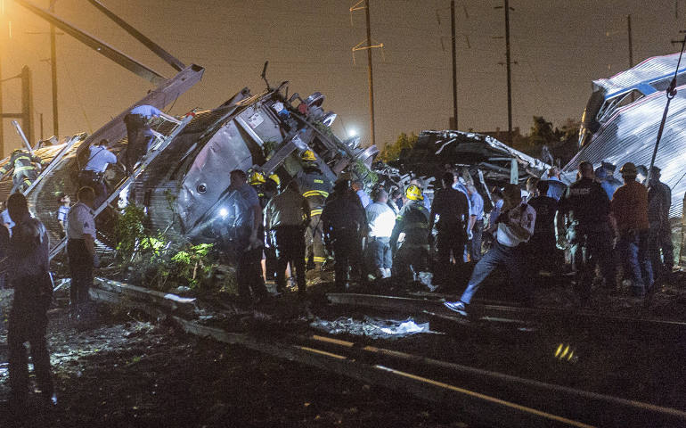 Rescue workers search for victims in the wreckage of a derailed Amtrak train in Philadelphia May 12. (CNS photo/Bryan Woolston, Reuters)