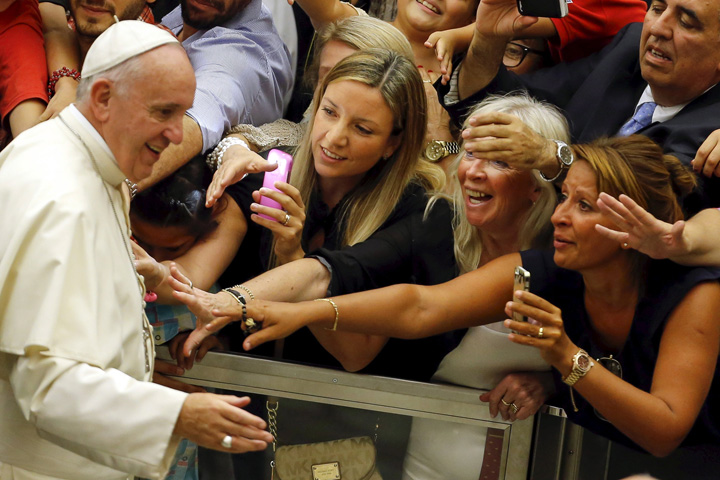 People react as Pope Francis arrives to lead his weekly audience in Paul VI hall at the Vatican Aug. 5. (CNS photo/Giampiero Sposito, Reuters)
