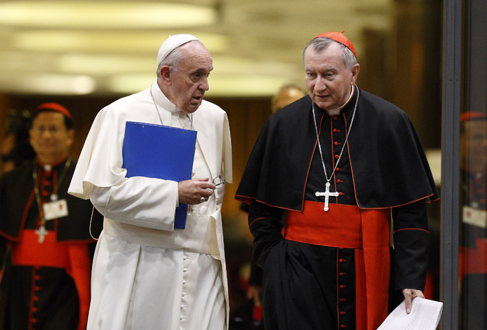 Pope Francis and Cardinal Pietro Parolin, Vatican secretary of state, talk as they leave the opening session of the Synod of Bishops on the family at the Vatican Oct. 5. (CNS photo/Paul Haring)