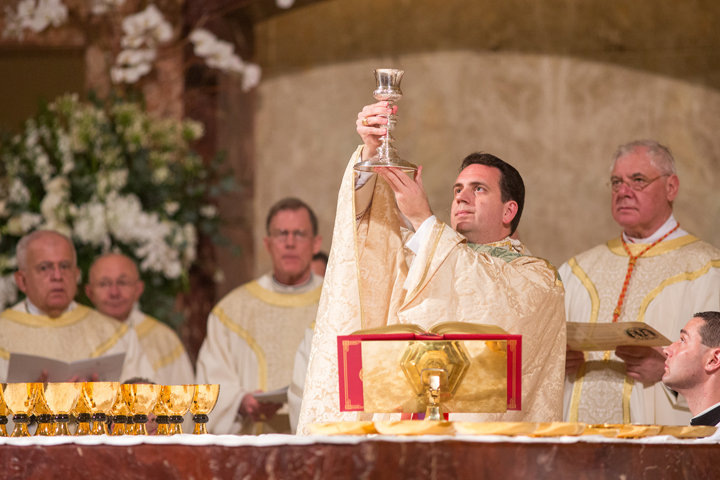 Bishop Steven J. Lopes raises the chalice during his Feb. 2 episcopal ordination Mass at the Co-Cathedral of the Sacred Heart in Galveston-Houston. (CNS/Tom McCarthy Jr.) 