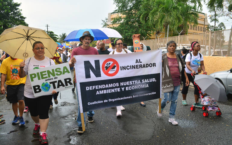 People carry banners during an April 30 march in Catano, Puerto Rico, to raise awareness about climate change. Members of several Catholic groups joined representatives of more than 30 organizations for the march to "raise awareness and call for immediate action" to preserve the environment and limit climate change. (CNS photo/Wallice J. de la Vega)