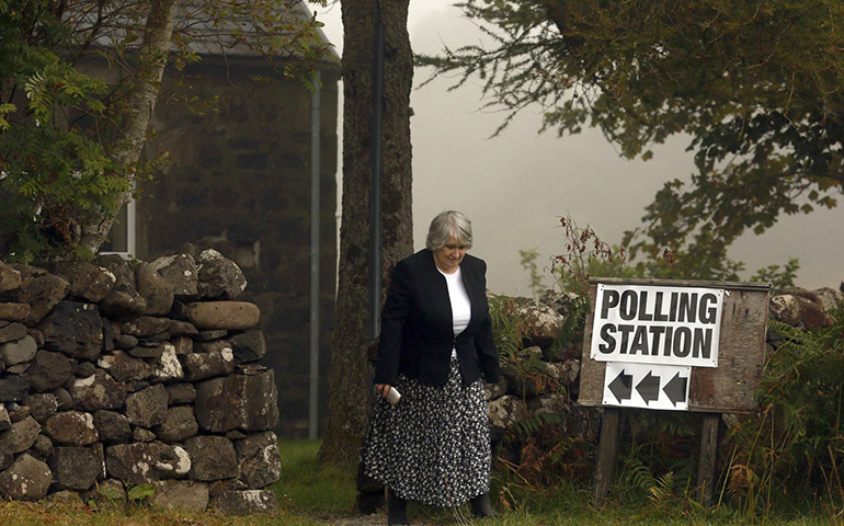 A voter leaves a polling station in 2014 in Portree, Scotland. That year Scots narrowly voted not to press ahead with national independence. (CNS/Cathal McNaughton, Reuters) 