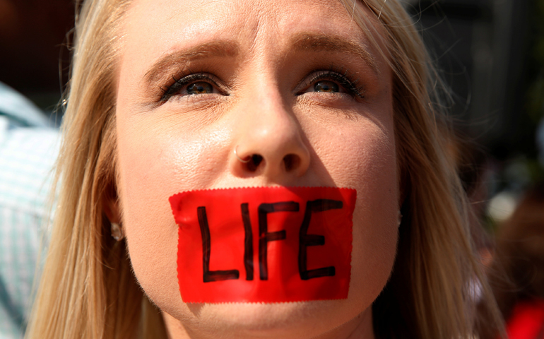 A pro-life supporter stands outside the U.S. Supreme Court June 27 during protests in Washington. (CNS/Kevin Lamarque, EPA)