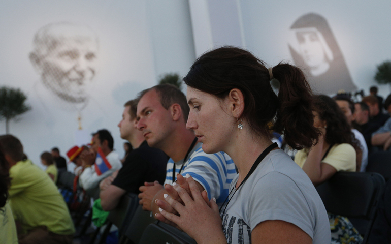 World Youth Day pilgrims pray as Pope Francis leads benediction during a July 30 prayer vigil as part of World Youth Day at the Field of Mercy in Krakow, Poland. (CNS/Paul Haring)