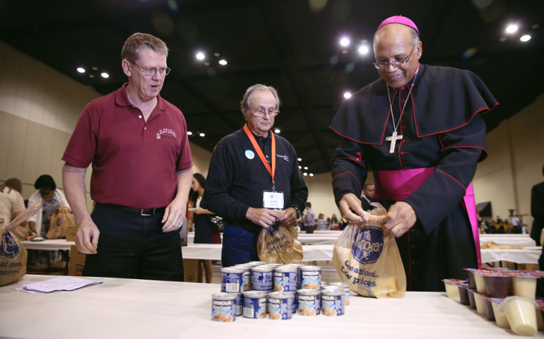 In one of his first acts as the new bishop of Memphis, Tenn., Bishop Martin Holley helps assemble bags of food for the homeless Oct. 21. He was installed Oct. 19. He was an auxiliary bishop in Washington, D.C., 2004-2016. (CNS/Jaclyn Lippelmann)