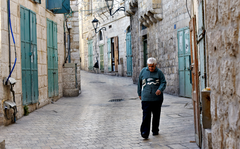 A Palestinian man walks on Star Street Dec. 5 in Bethlehem, West Bank. (CNS/Debbie Hill)