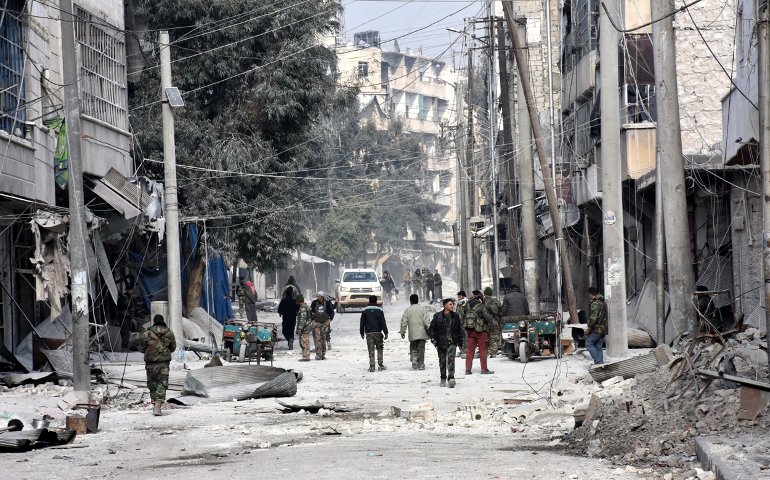Syrian soldiers patrol a neighborhood in Aleppo Dec. 12 after recapturing it from rebels. (CNS/SANA news agency via EPA) 