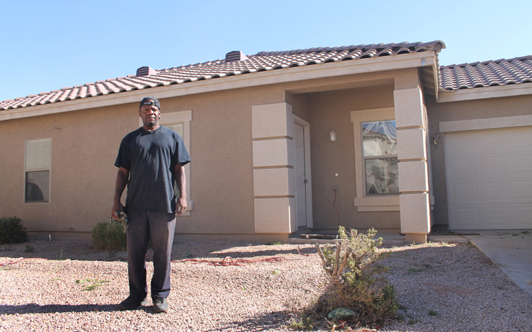 Terrance Alston poses in November in front of a vacant house he helped renovate in Chandler, Ariz. (CNS/Catholic Sun/Ambria Hammel)