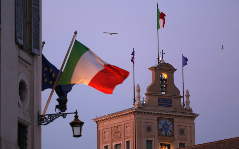 Italian flags blow in the breeze outside the presidential palace in Rome on Dec. 22. When Italians go to the polls Feb. 24, the pope and other church officials will be watching closely. (CNS/Reuters/Alessandro Bianchi)