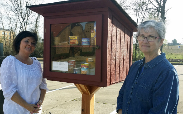Betty Rose Neumeier and Annie Woody, members of St. Michael's Catholic Church in Van Buren, Arkansas, are two of the volunteers who stock the parish's blessing boxes. (CNS photo/Maryanne Meyerriecks, Arkansas Catholic)