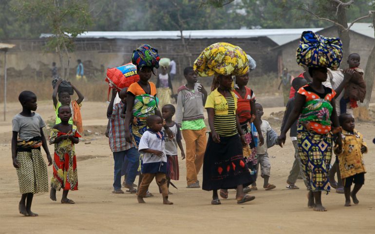 Displaced people fleeing violent protests in Congo arrive Feb. 17 in Ntoroko, Uganda. (CNS/Reuters/James Akena)