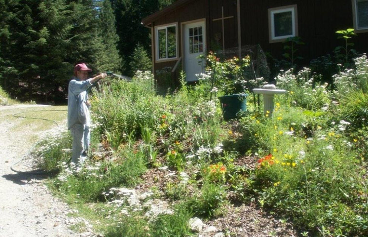 Carmelite Sr. Nancy Casale waters the garden at the Mary Regina house, with a chapel, library, laundry facility, business office, guestrooms, a community kitchen, dining room and living room. (Provided photo)