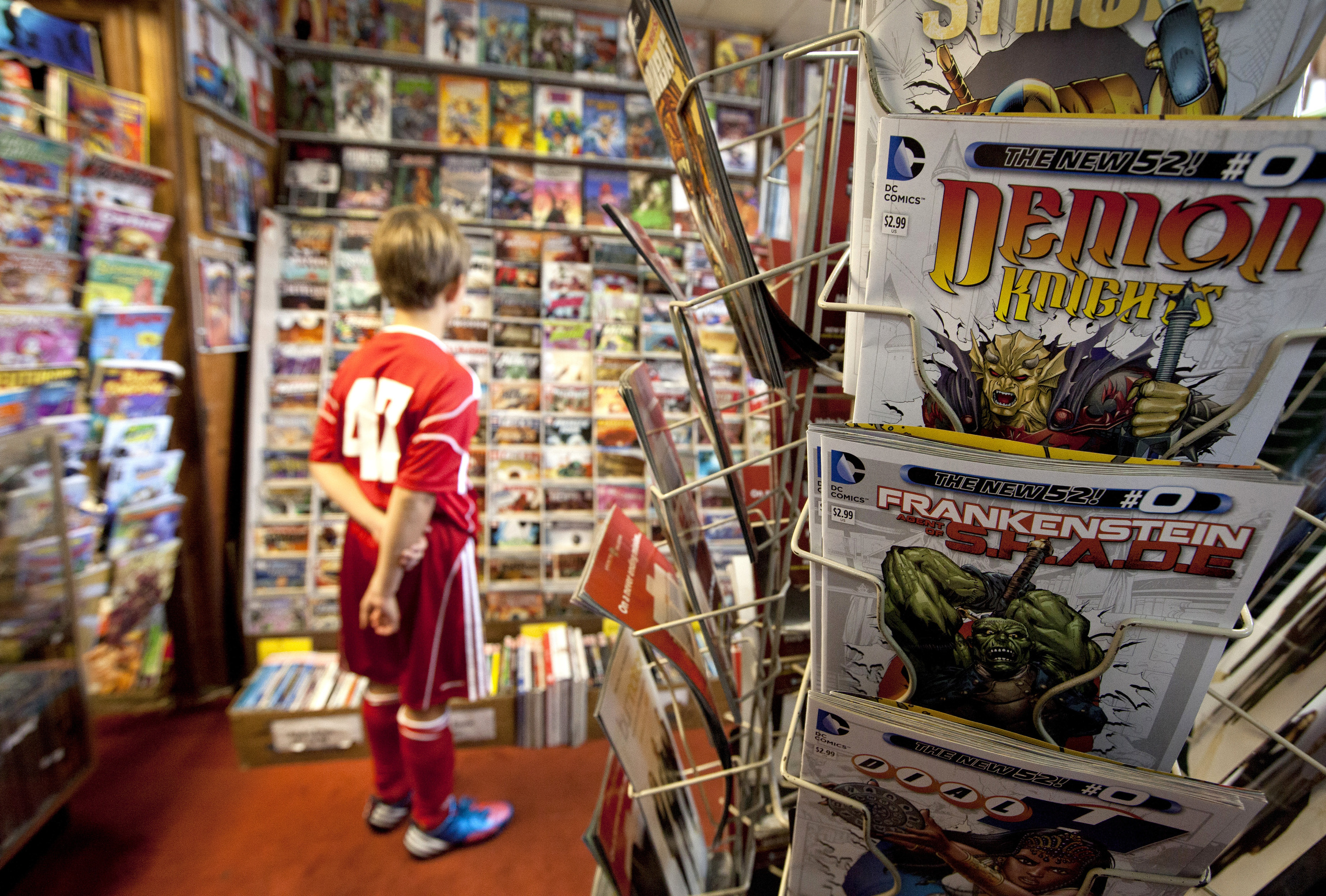 A young visitor studies the stacks at Aftertime Comics store in Alexandria, Va., Sept. 16. (CNS/Nancy Phelan Wiechec) 