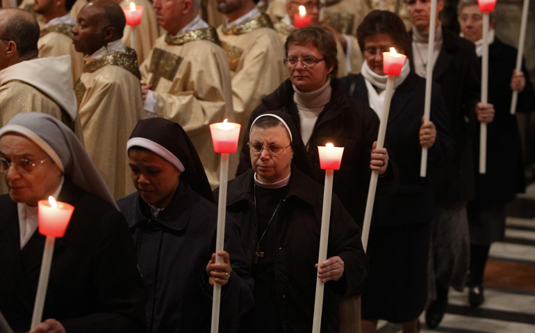 Religious carry candles in procession at the start of a Mass celebrated Monday by Pope Francis to mark the feast of the Presentation of the Lord. The Mass in St. Peter's Basilica at the Vatican also marked the World Day for Consecrated Life. (CNS/Paul Haring) 