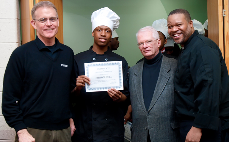 From left to right: Precious Blood Fr. David Kelly, culinary arts participant Shawn Reed, receiving his certificate of completion, Judge Terrence Sharkey, and La'Vern Russell (Courtesy of the Precious Blood Ministry of Reconcilation)