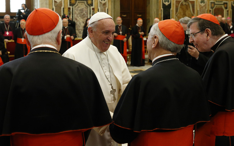 Pope Francis exchanges Christmas greetings with members of the Roman Curia on Monday in Clementine Hall at the Vatican. (CNS/Paul Haring)