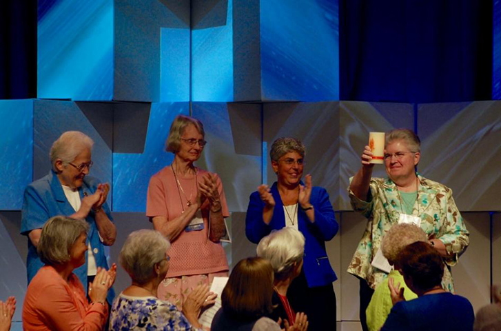 Outgoing LCWR president Sr. Carol Zinn, SSJ, right, acknowledges the applause Friday at the Leadership Conference of Women Religious' annual assembly in Houston. Next to her, from left, are Past-President Sharon Holland, IHM, Sr. President Marcia Allen, CSJ, and President-Elect Sr. Mary Pellegrino, CSJ. (GSR photo/Dan Stockman)