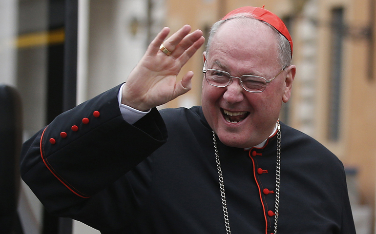 Cardinal Timothy Dolan of New York waves as he arrives for a general congregation meeting Wednesday in the synod hall at the Vatican. (CNS/Reuters/Tony Gentile)