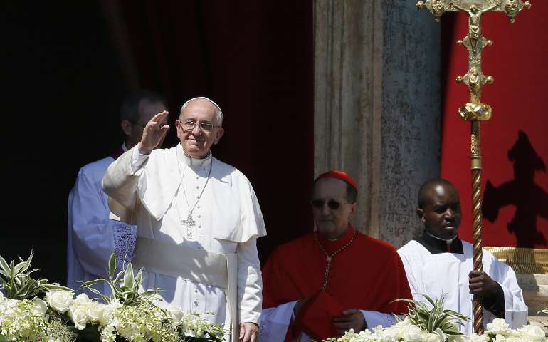 Pope Francis greets the crowd after delivering his Easter blessing "urbi et orbi" (to the city and the world) from the central balcony of St. Peter's Basilica at the Vatican April 20. (CNS photo/Paul Haring)
