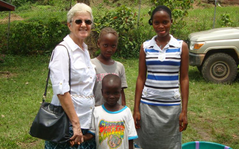 Sr. Ann Kelly in Voinjama, Liberia, with three orphaned children the sisters cared for during the Ebola crisis. The children have since been reunited with family members. (Courtesy Missionary Sisters of the Holy Rosary)