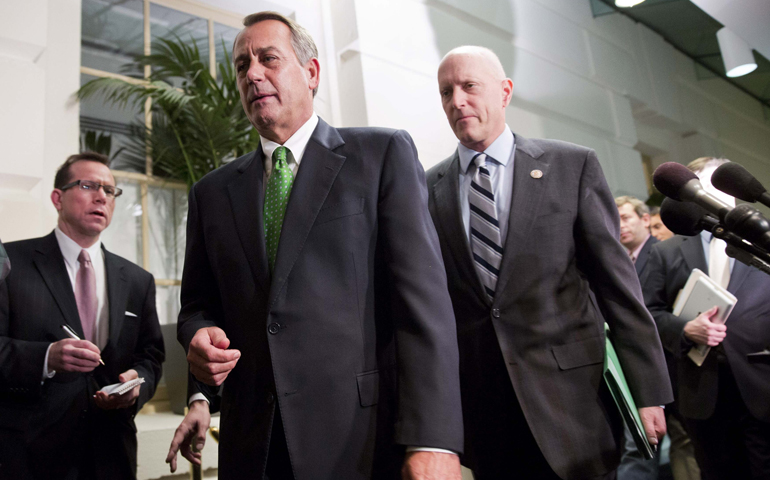 Speaker of the House John Boehner walks with Rep. Dave Camp, R-Mich., after a meeting with House Republicans about a "fiscal cliff" deal on Capitol Hill in Washington Jan. 1. (CNS/Reuters/Joshua Roberts)