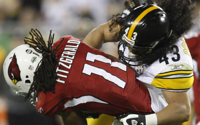 Pittsburgh Steelers safety Troy Polamalu tackles Arizona Cardinals wide receiver Larry Fitzgerald during the 2009 Super Bowl in Tampa, Fla. (CNS/Gary Hershorn)