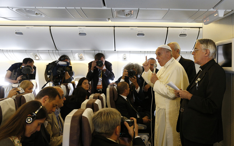 Pope Francis answers questions from journalists aboard the papal flight Monday from Seoul, South Korea, to Rome. (CNS/Paul Haring) 