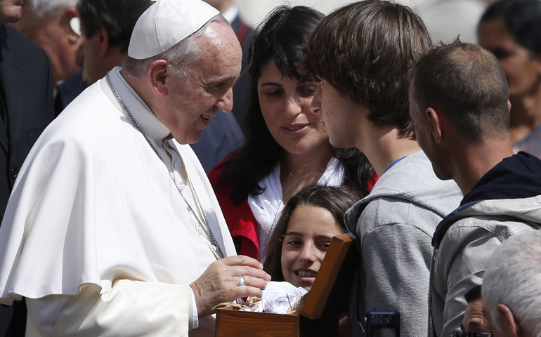 Pope Francis talks to young people during his general audience Wednesday in St. Peter's Square at the Vatican. (CNS/Paul Haring) 