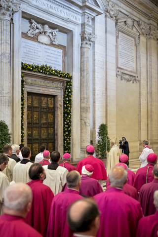 Pope Francis stands in front of the Holy Door prior to first vespers of Divine Mercy Sunday in St. Peter's Basilica on Saturday at the Vatican. (CNS/Reuters pool/Andrea Solaro)