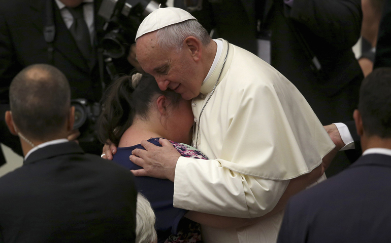Pope Francis embraces a woman during his weekly audience Wednesday in Paul VI hall at the Vatican. (CNS/Reuters/Alessandro Bianchi)