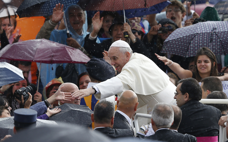 Pope Francis greets people as he arrives to lead his general audience in St. Peter's Square at the Vatican Oct. 9. (CNS/Paul Haring) 