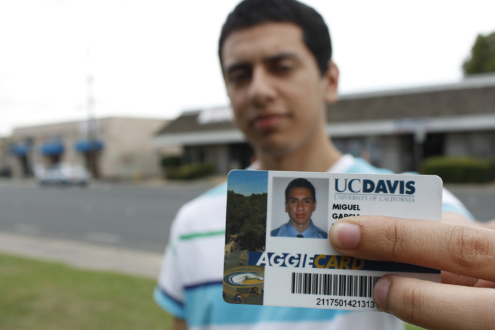 Miguel Garcia shows his UC Davis ID card.