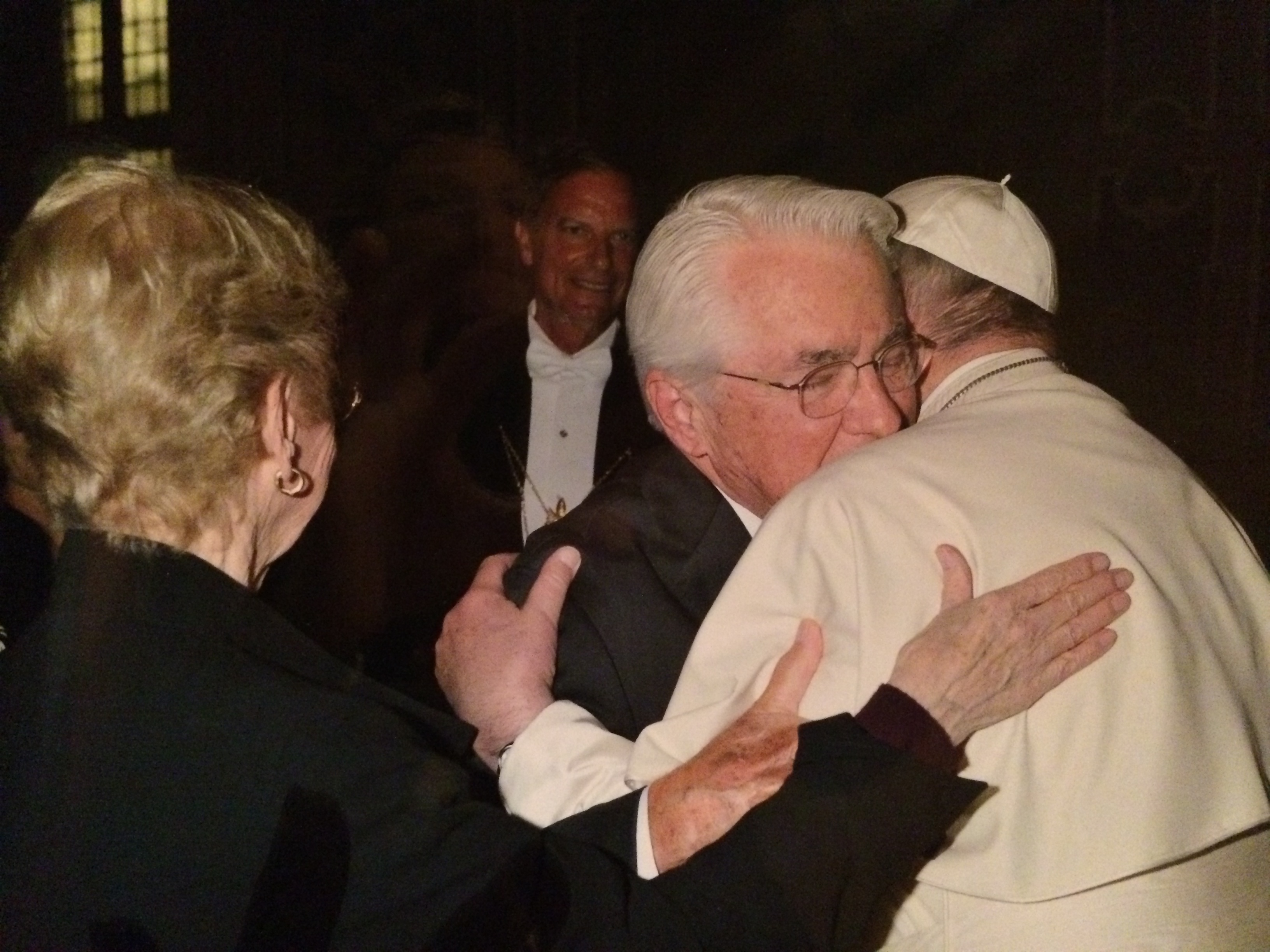 Gene Frey embraces Francis as wife, Mary, looks on, placing her hand on Francis' arm  (Vatican photo)