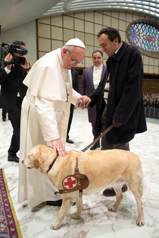 Pope Francis greets a man with a guide dog at a March 16, 2013, general audience in the Paul VI hall at the Vatican. (CNS/L'Osservatore Romano)