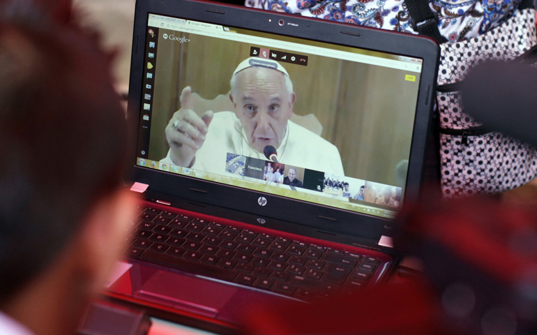 Pope Francis video chats Thursday with a Salvadoran student in the gang-infested neighborhood of La Campanera, San Salvador. (CNS/Reuters/Jose Cabezas)
