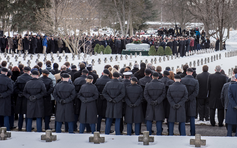 Mourners surround the casket of Holy Cross Fr. Theodore Hesburgh during his burial service Wednesday at Holy Cross Community Cemetery on the campus of the University of Notre Dame in Indiana. (CNS/University of Notre Dame/Matt Cashore)