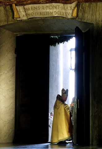 Pope John Paul II pushes open the Holy Door and walks into St. Peter's Basilica on Christmas Eve 1999. (CNS/Vatican/Arturo Mari)