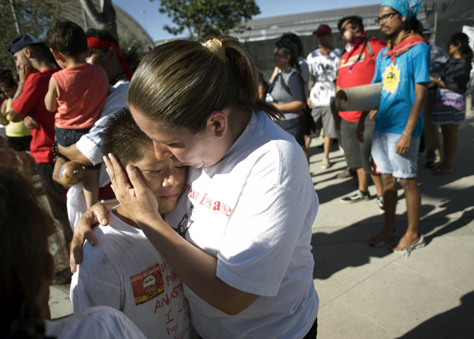 Daniel Hernandez gets a hug from his mother, Maria Puga, during an Aug. 16 rally to mark the end of the Trail for Humanity immigrant rights caravan in San Diego. (CNS/EPA/David Maung)