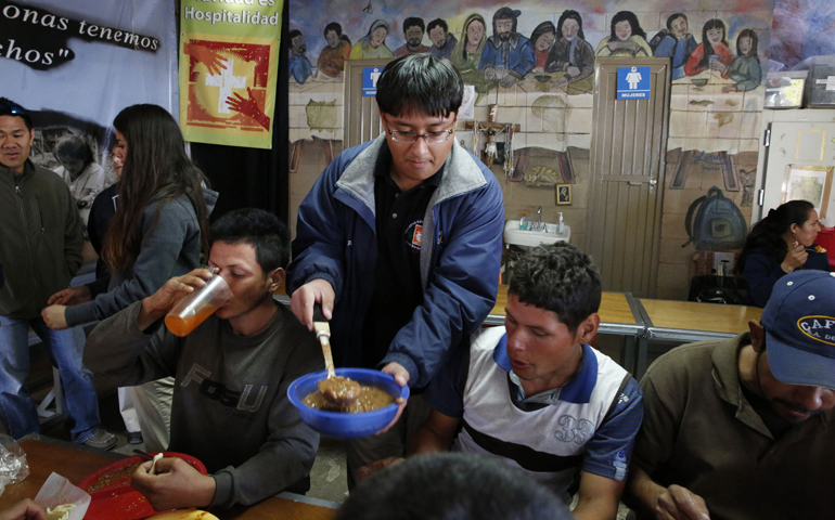 Kino teen Gerardo Perez serves beans to deported migrants in 2014 at the "comedor," the kitchen and dining hall of the Aid Center for Deported Migrants in Nogales, Mexico. (CNS/Nancy Wiechec)