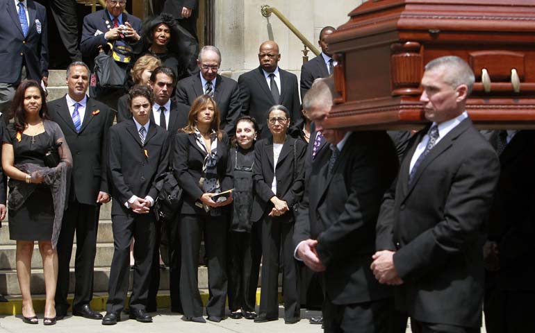Family members watch as the casket of entertainer and civil rights activist Lena Horne is carried away at her May 14, 2010, funeral at the Church of St. Ignatius Loyola in New York. (CNS/Reuters/Brendan McDermid)